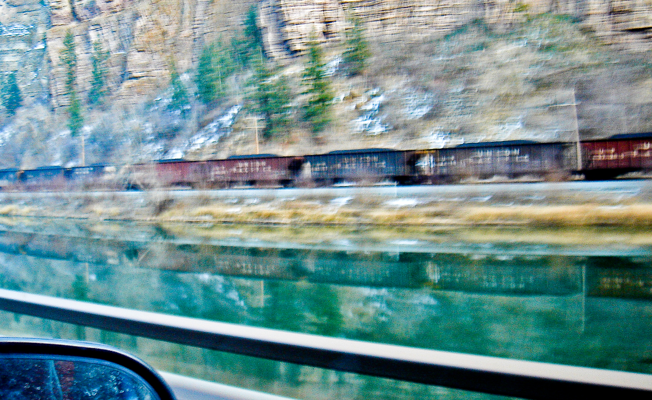 Motion blur, train along canyon wall